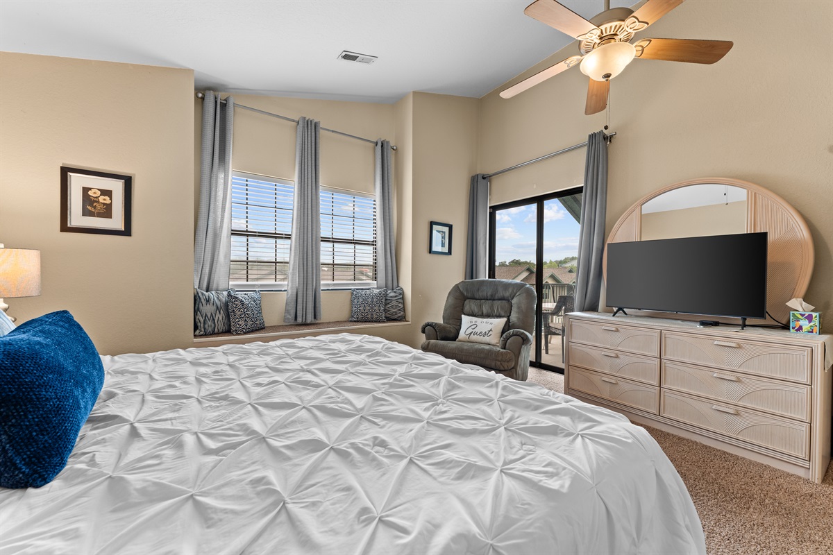 The primary bedroom includes its own TV and seating area, giving it the feel of a true suite.