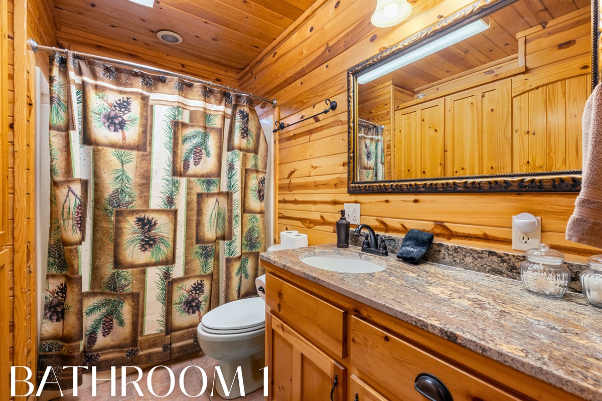 Bathroom with rustic vanity and shower/tub combo.