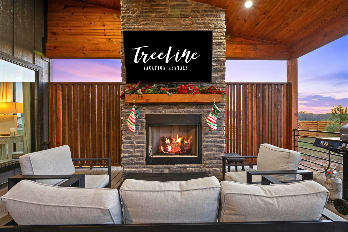 The cozy outdoor fireplace creates a relaxing lounge space where you can unwind with a drink and enjoy the evening glow.