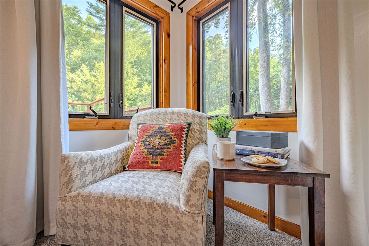 Tucked into the corner, this inviting chair sits beside sunlit windows that bring the beauty of the outdoors inside.