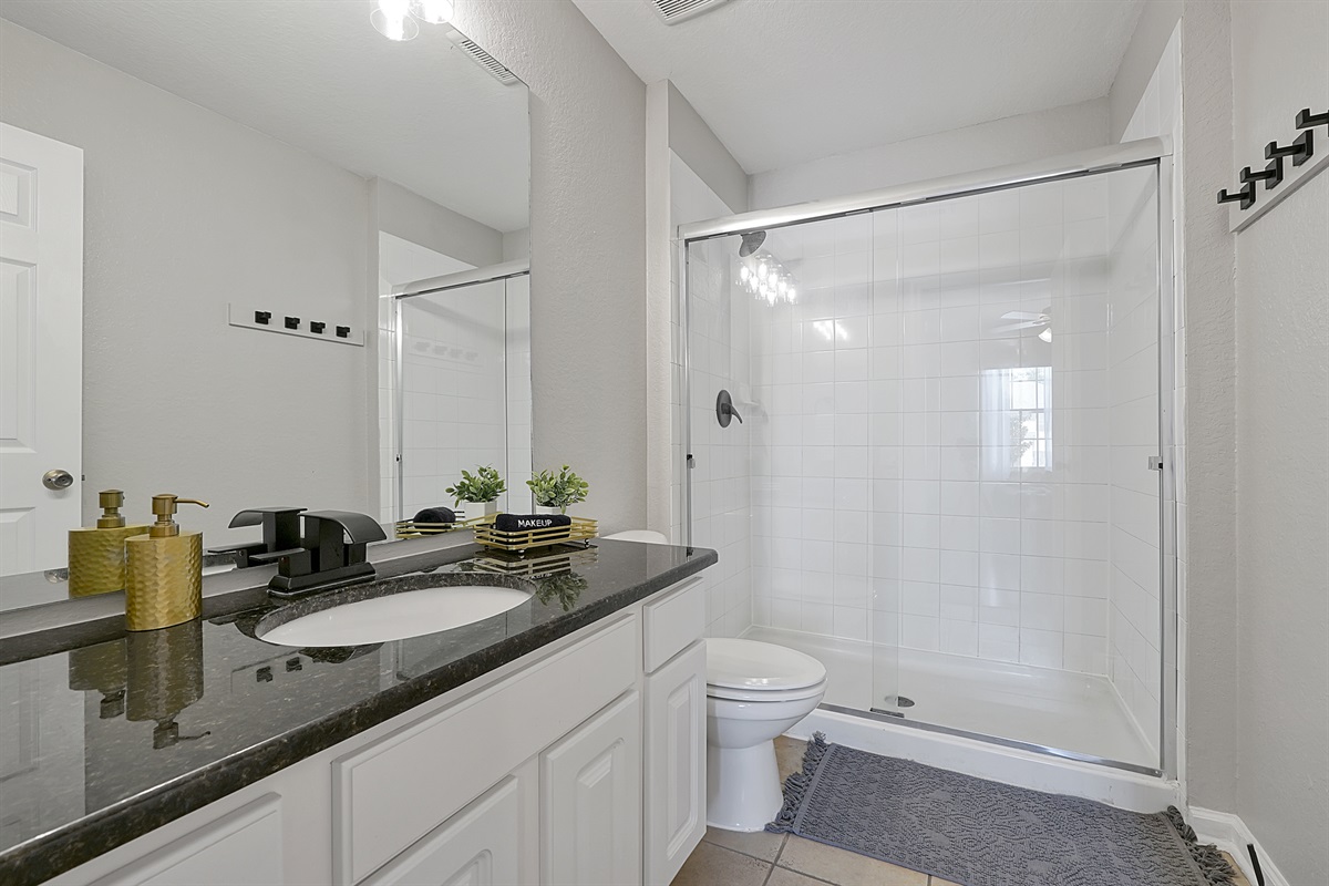 The full Aladdin bath features gold accents and a new faucet and shower head.
