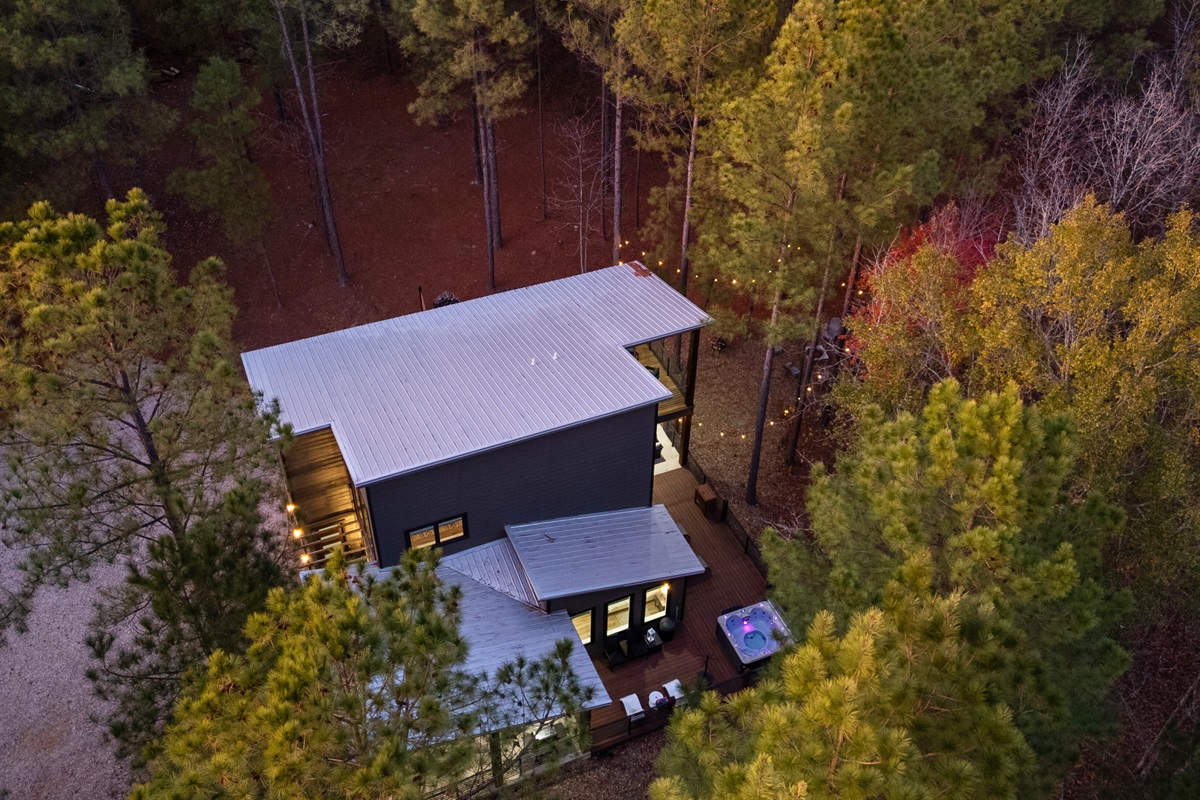 An aerial view shows how thoughtfully the cabin is positioned within the surrounding trees.