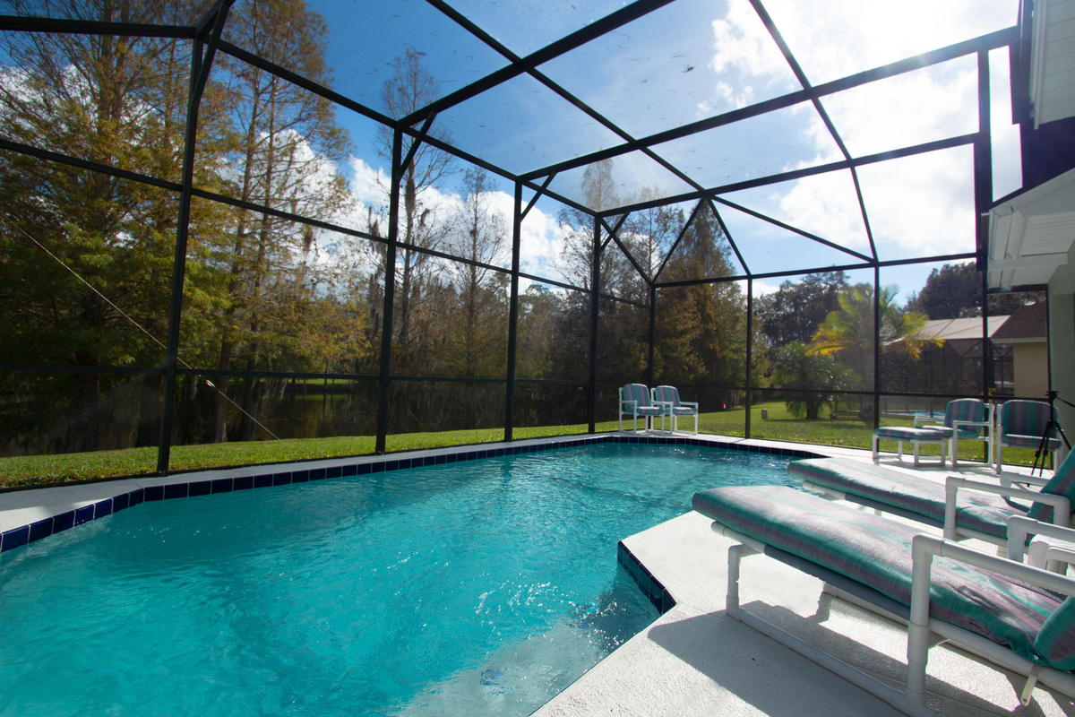 Relax by your Private Screened Pool with a gorgeous view of the lake!