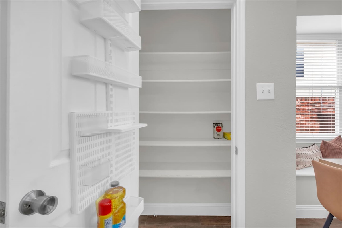 Spacious, clean, and clutter-free pantry offering ample storage for groceries during family or extended stays.