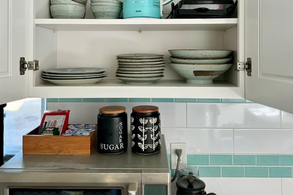 A full set of plates, bowls, silverware and glassware, perfectly arranged for you.