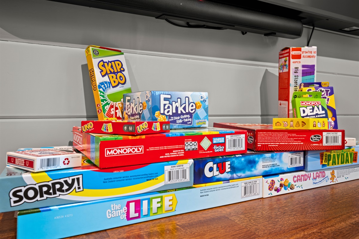 A shelf stocked with board games provides plenty of options for family game nights and rainy-day fun.