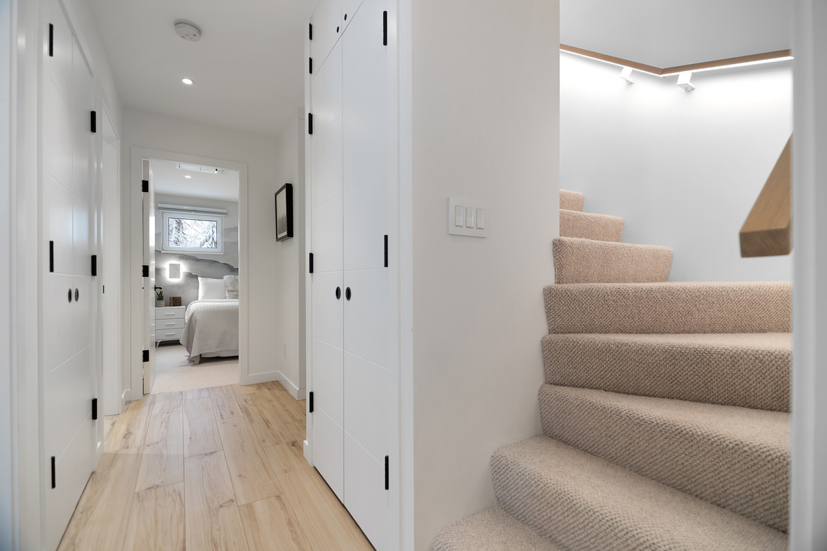 Upstairs hallway and carpeted staircase