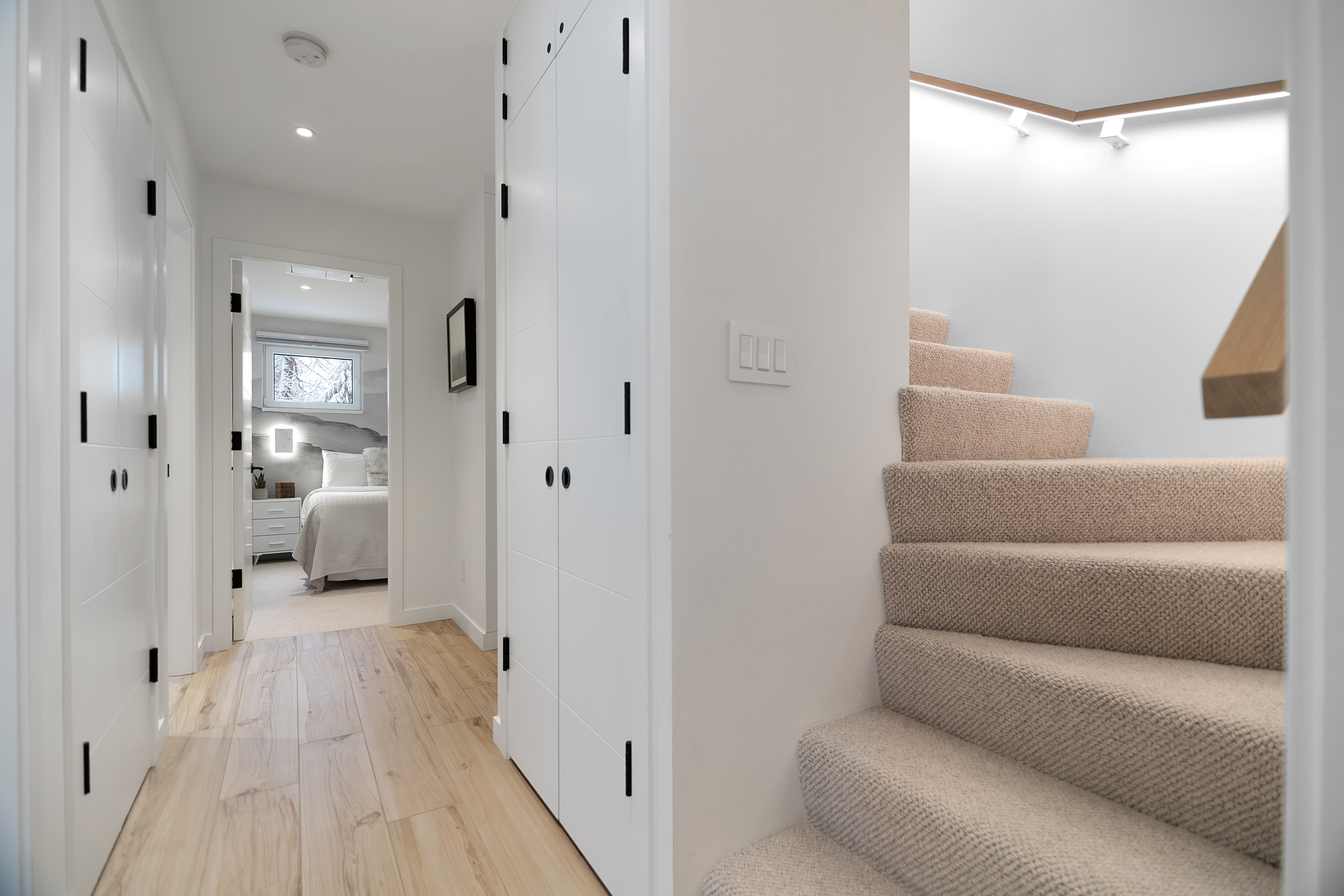 Upstairs hallway and carpeted staircase