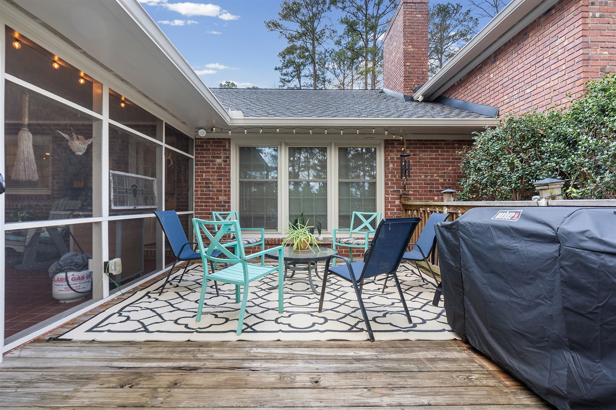 Porch with ample seating and a small table, perfect for relaxing or working outdoors