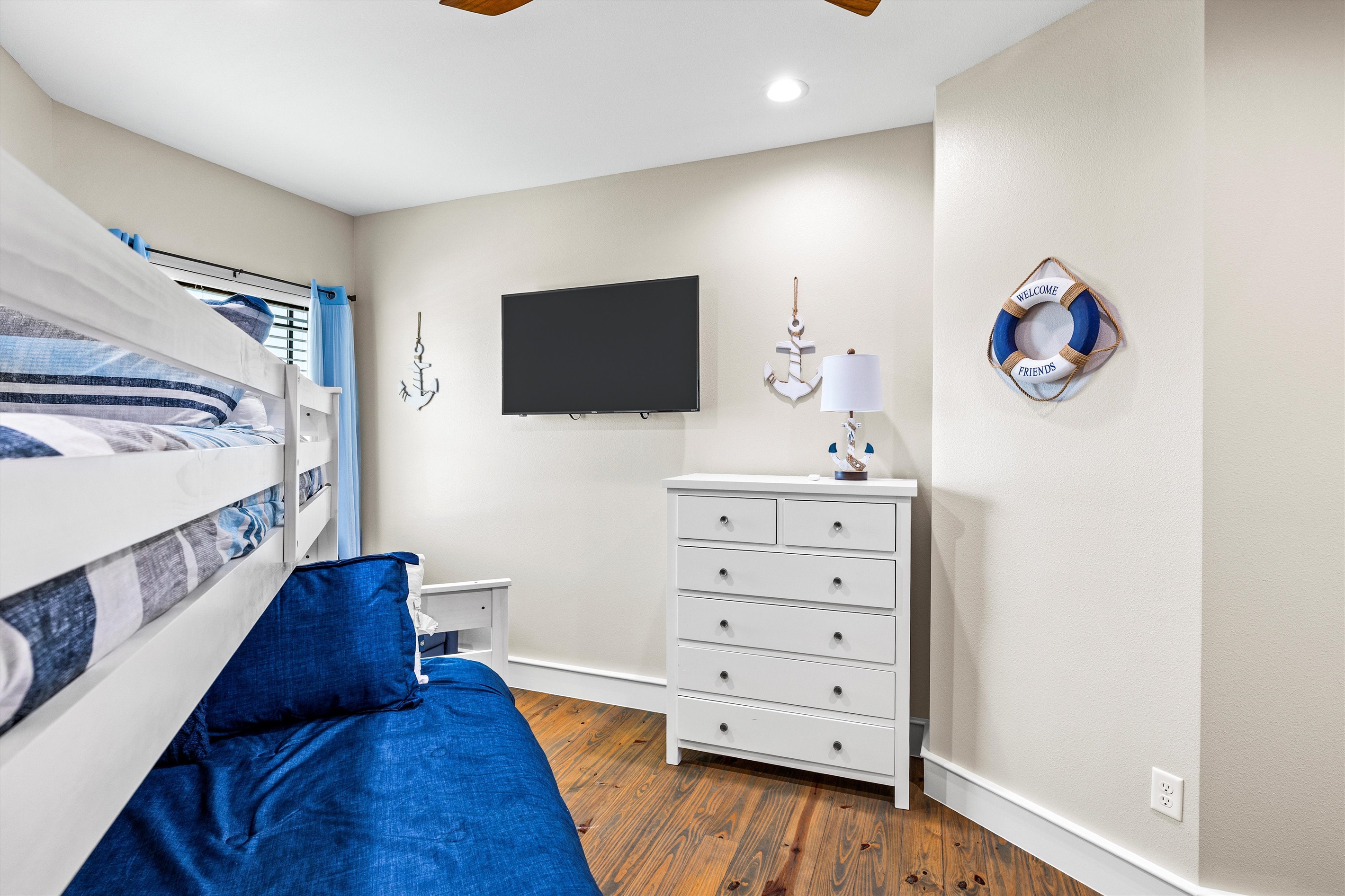 Bunk Room: Nautical charm with vibrant decor, perfect for kids’ adventures and family fun!