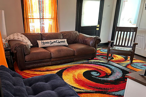Your home away from home! Leather couch and rocker, 65" Roku tv, Blue chair opens to twin bed for a child.