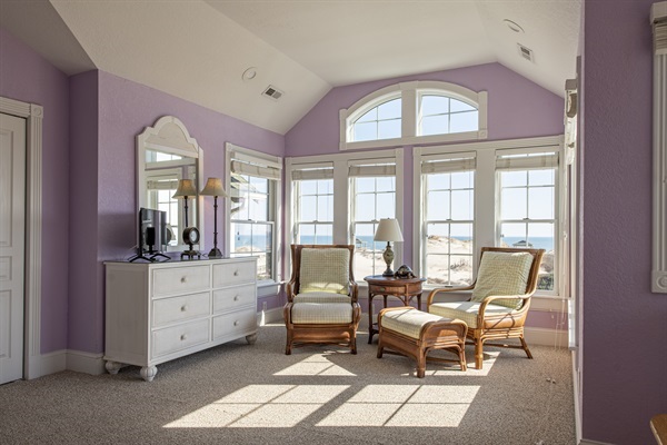 Escape to The Hemingway's master bedroom for a tranquil getaway. This serene, private retreat is complete with two arm chairs, making it the perfect spot for relaxation, rest, and rejuvenation