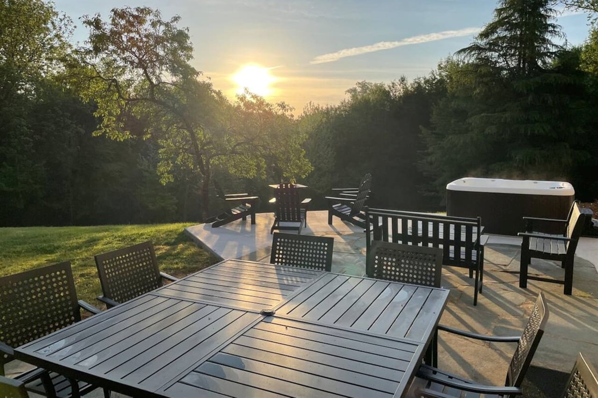 Outdoor dining, fire pit, and hot tub that is shared with any other guests staying in the private suites at Southern Guesthouse.