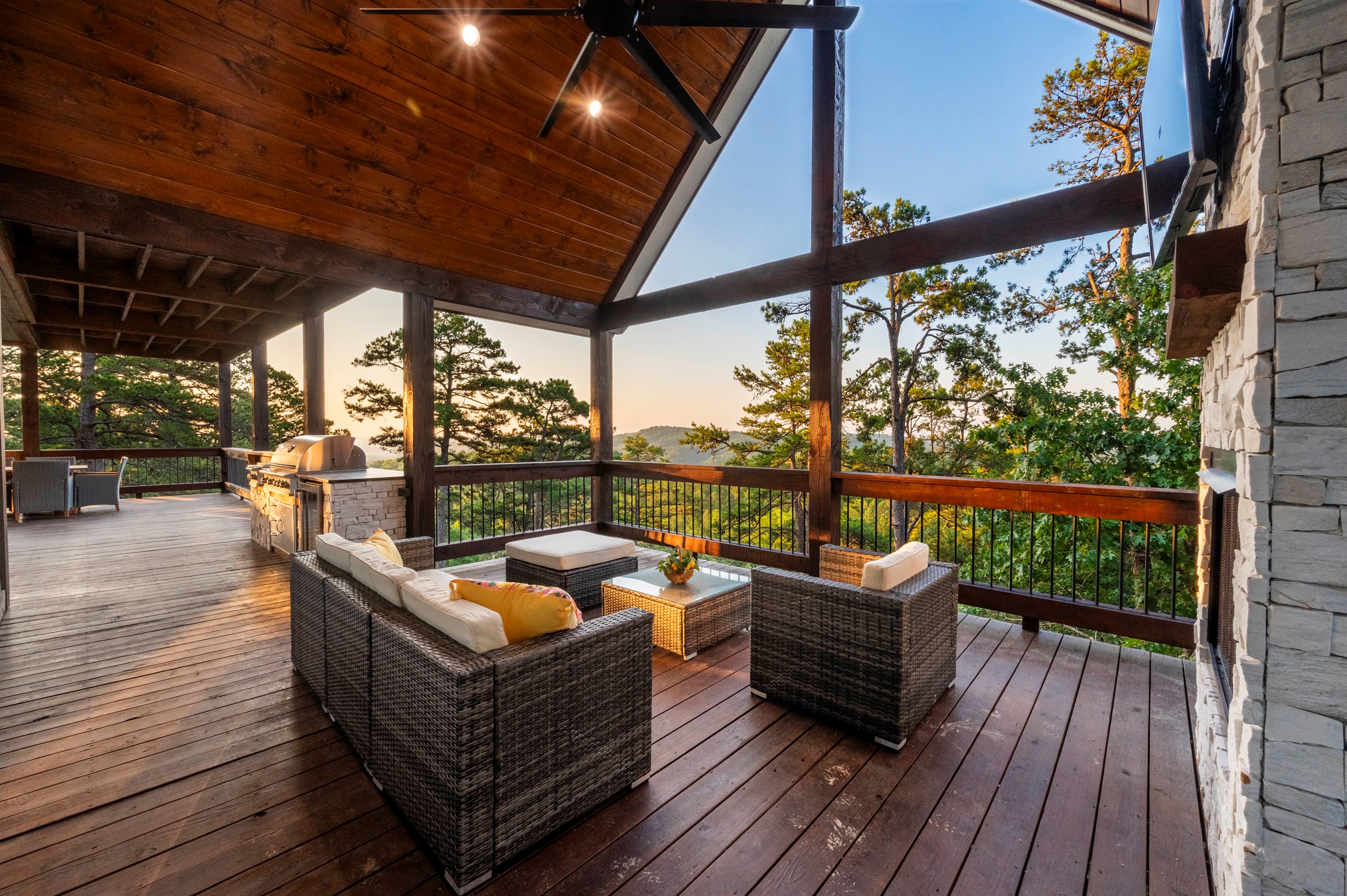 Expansive covered deck with cozy seating and breathtaking mountain scenery