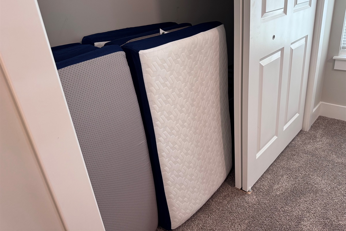 tri-fold twin mats in primary bedroom closet