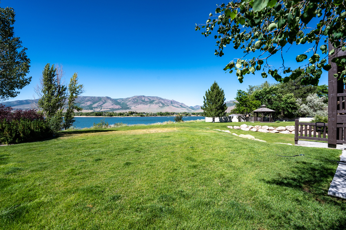 Expansive lakeside lawn offers space to relax and enjoy the scenery.