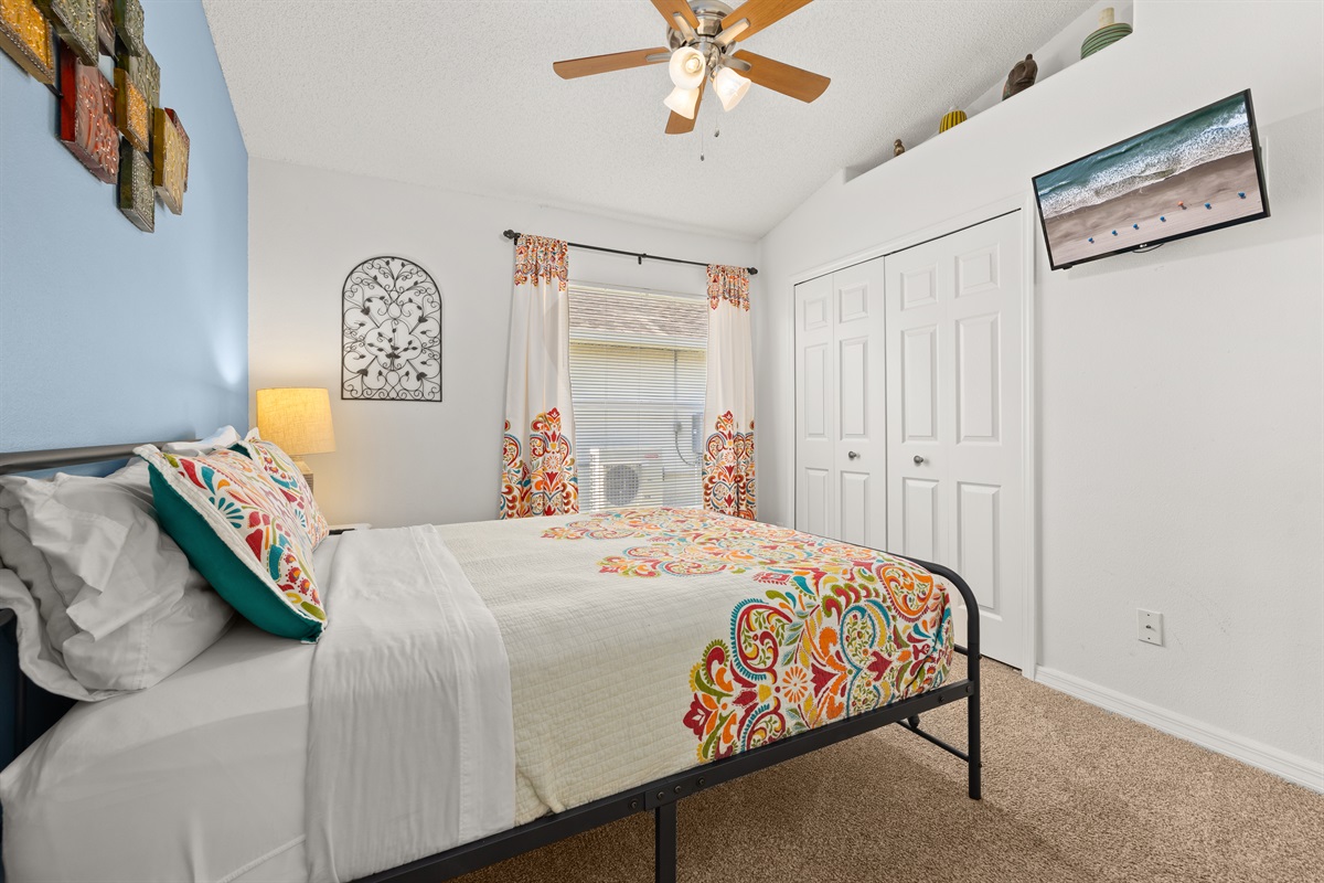 Wall mounted TV and closet in the queen suite.