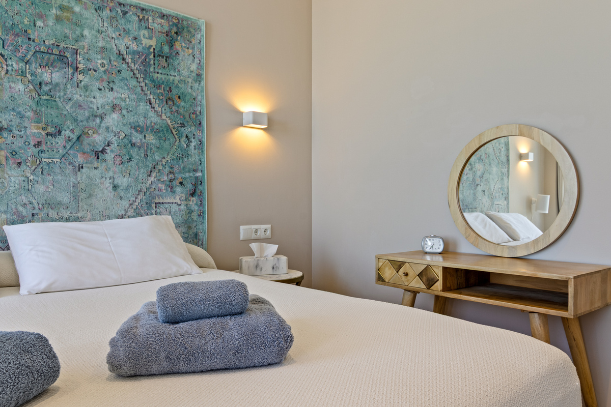Bedroom detail with bed, vanity corner and soft lighting