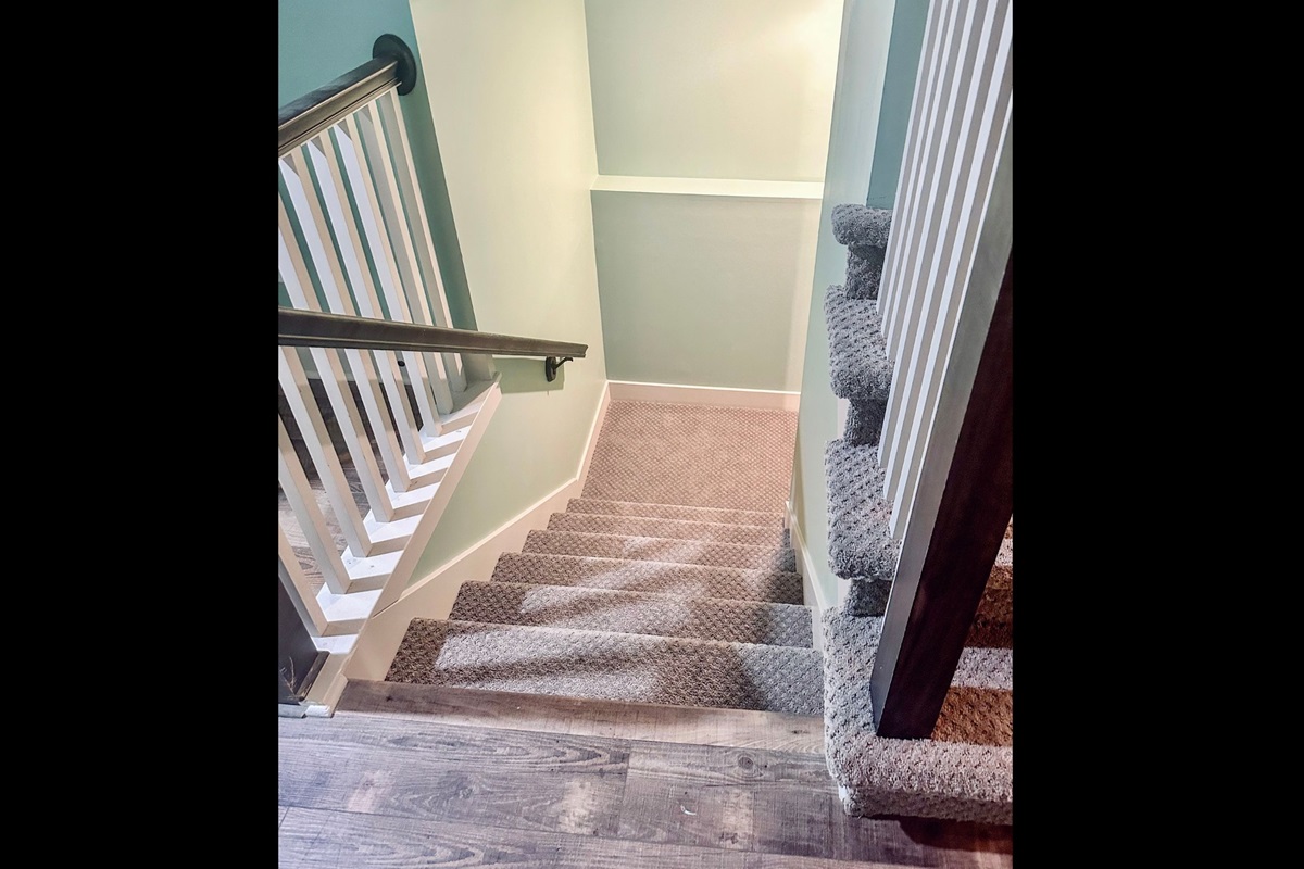 Main-level stair landing with access to the lower level, offering seamless flow between living spaces.