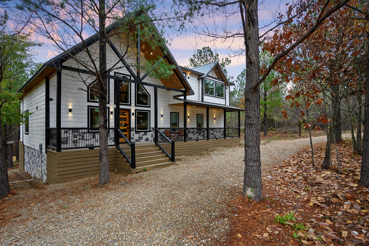 Welcome to Hit Refresh, tucked peacefully among the pines and ready for your next getaway. 
Glowing windows, cozy covered decks, and a quiet forest setting, this cabin instantly feels like the kind of place where life slows down and good memories begin.