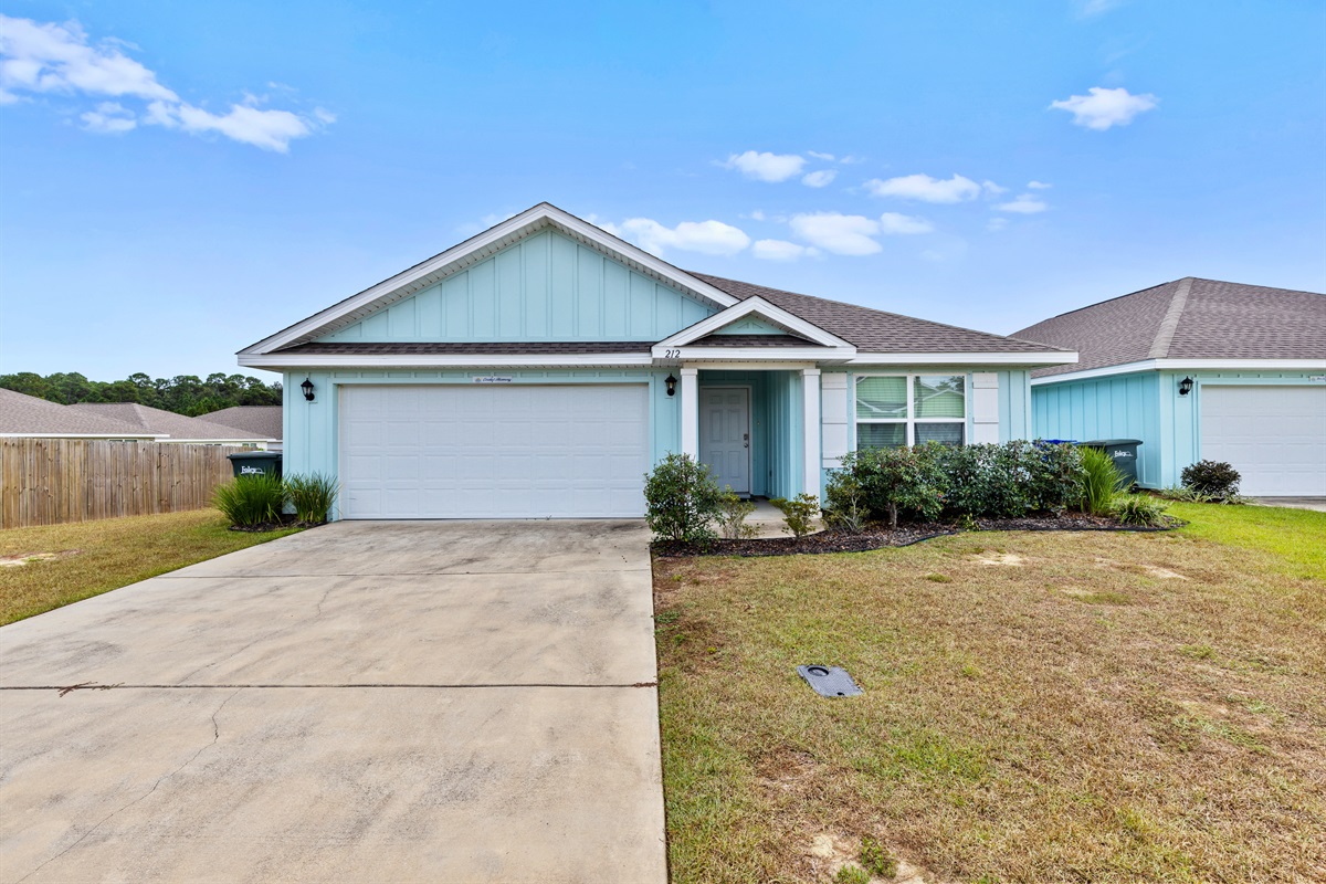 Front view of the home with tidy landscaping and plenty of parking.