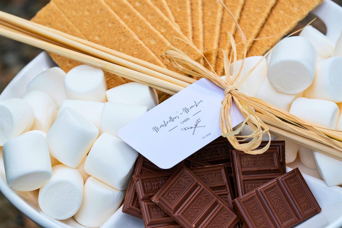 A delicious arrangement of marshmallows, chocolate, and graham crackers invites guests to enjoy a classic treat by the fire.