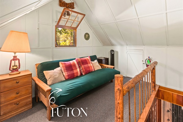 The upstairs futon lounge provides extra sleeping space and a quiet retreat to relax.