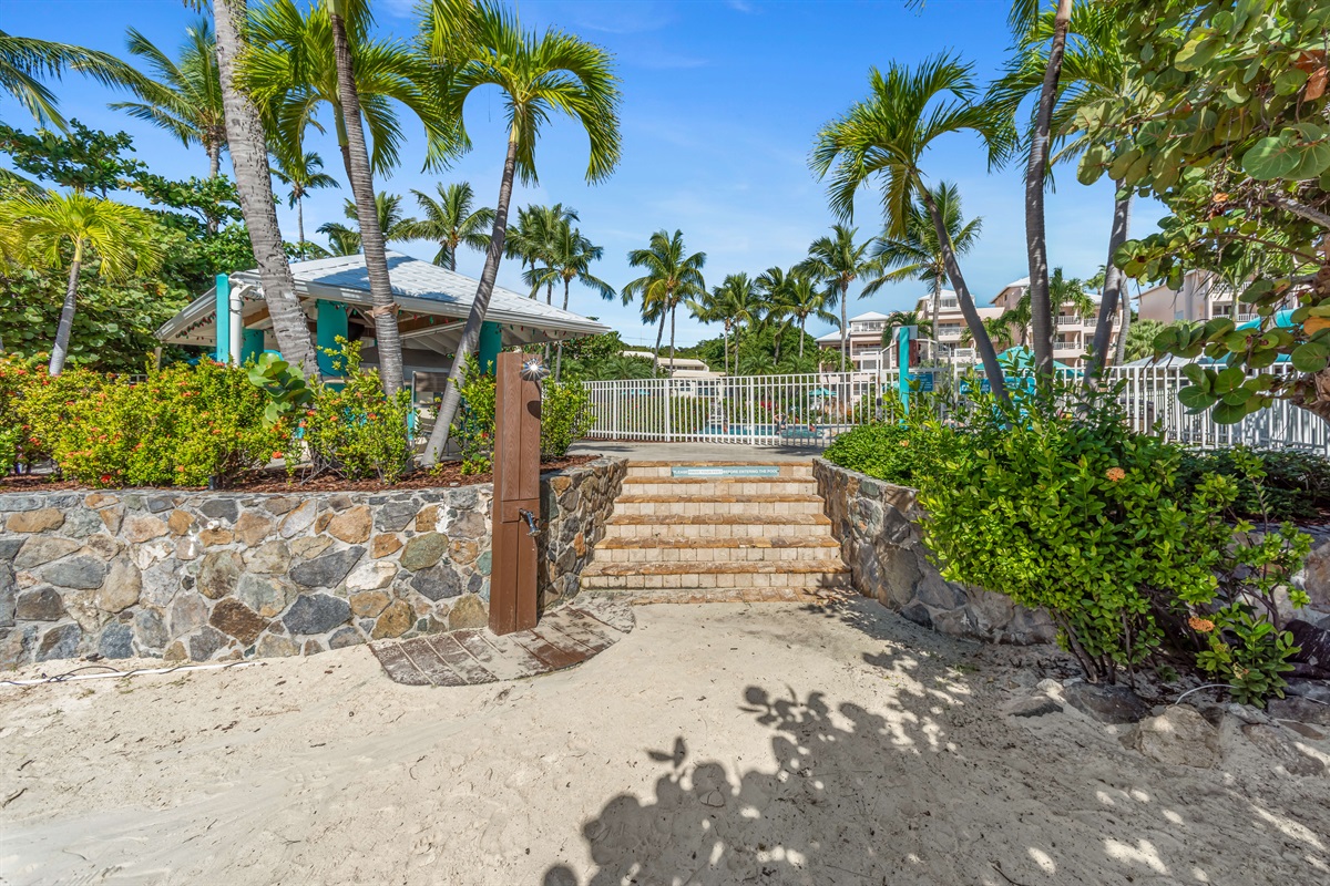 There's a sand rinse off shower right at the entrance to the pool. The pool is about a 6-7 minute walk from the condo.