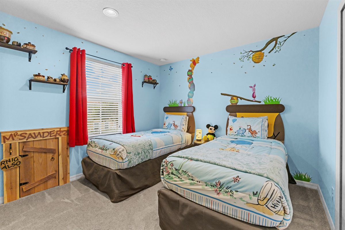 Winnie the Pooh themed twin bedroom with themed murals that your kids will love.