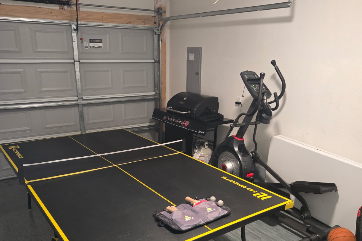 Full size ping pong table with paddles and balls, and propane grill, and eliptical machine.
