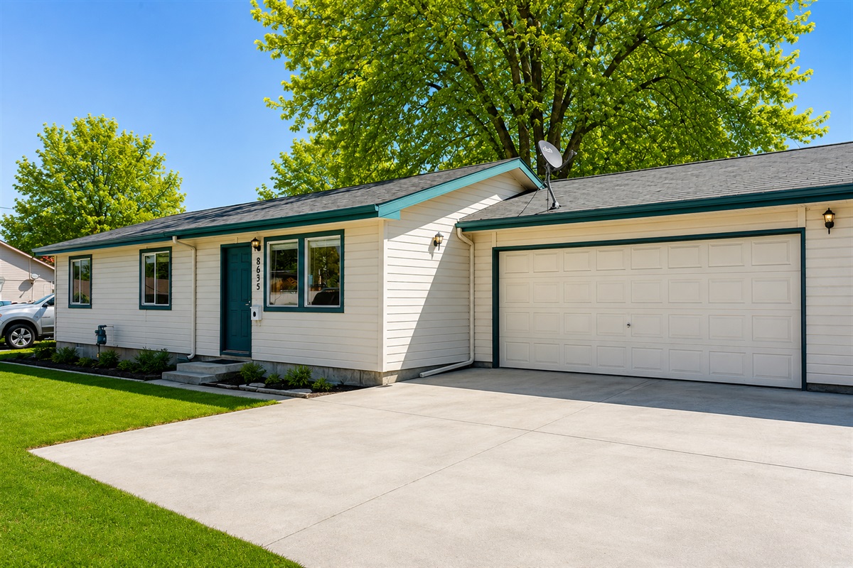 View of home and 2-car garage.