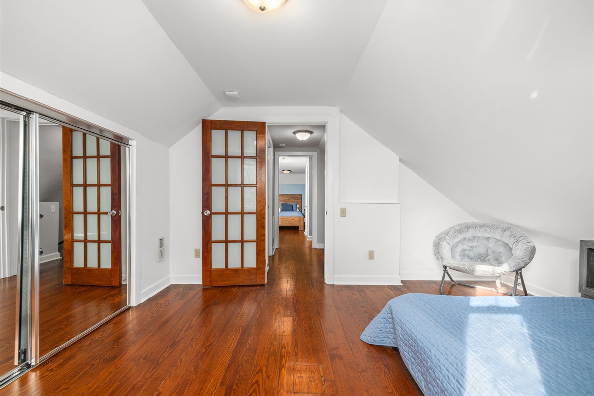 Upstairs bedroom 3, Full size bed with built in USB charging station and power outlet. Space includes children's books and a few toys for the kids .  Cozy chair for reading or lounging, black