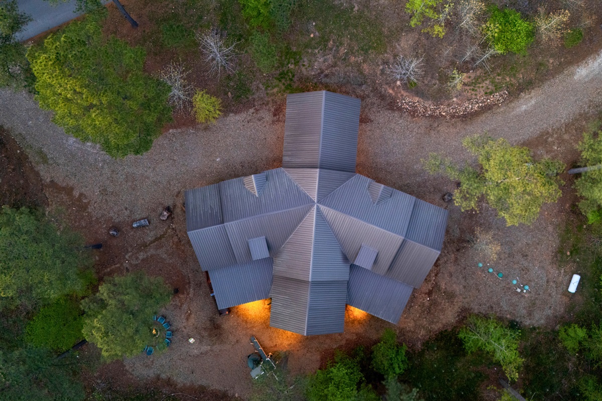 An aerial perspective offers a unique look at the property, giving you a sense of the space and the serene wooded setting it sits within.