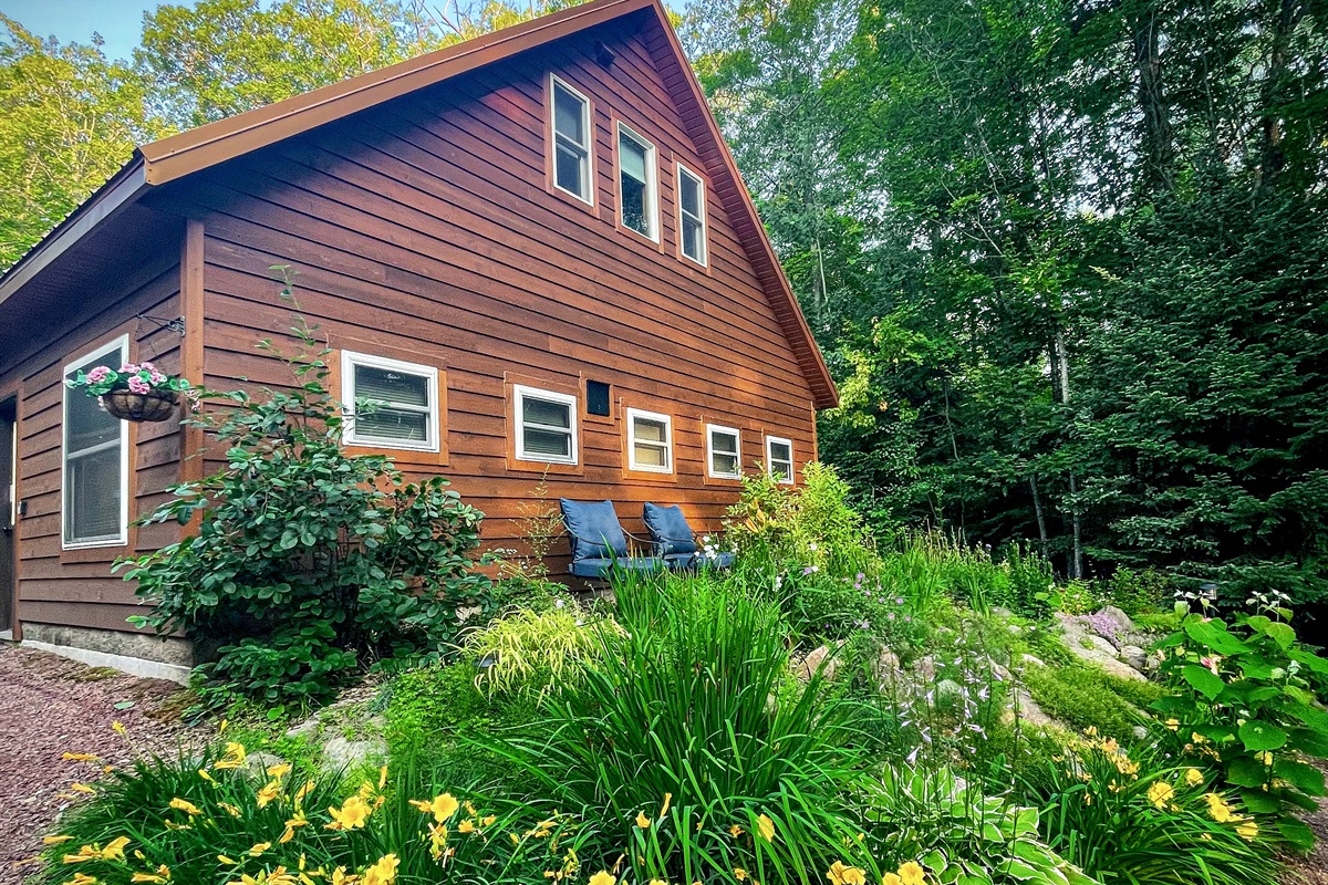 Front entrance and Rock Garden perennial pathway with two lounge chairs perfect spot for morning coffee