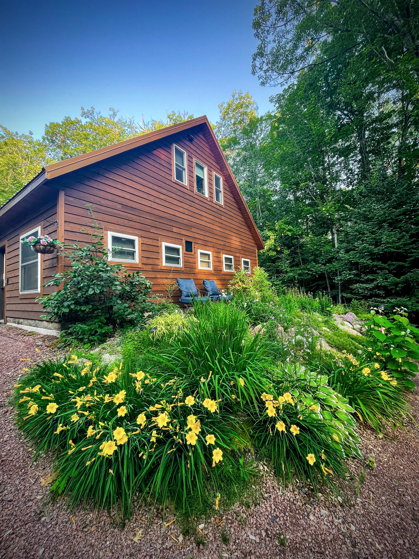 Front entrance and Rock Garden perennial pathway with two lounge chairs perfect spot for morning coffee