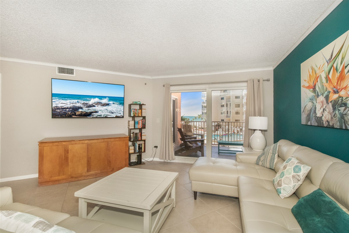 Huge open cozy living room with 70-inch LED Smart TV, Fireplace and Gulf Views