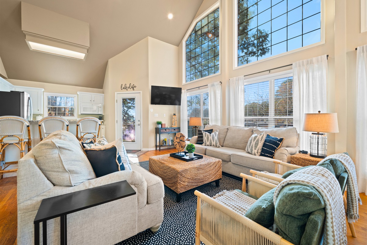 This inviting living area feels even brighter with natural light spilling in from every direction.