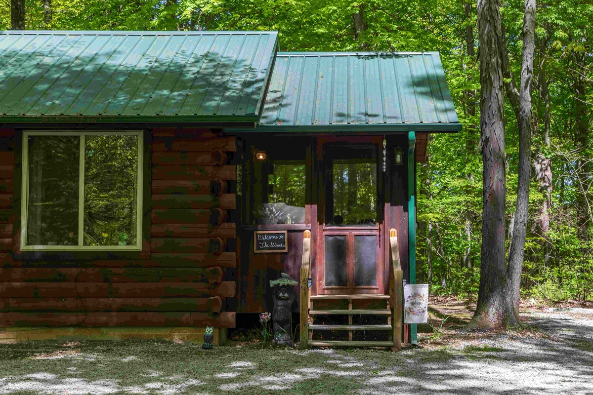 The front door is inside the screened in porch area.