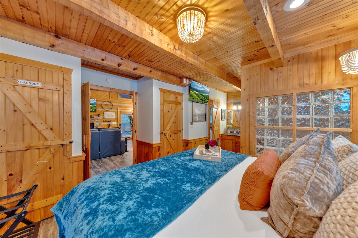 Cozy retreat with log walls, plush bedding, and glowing ambiance