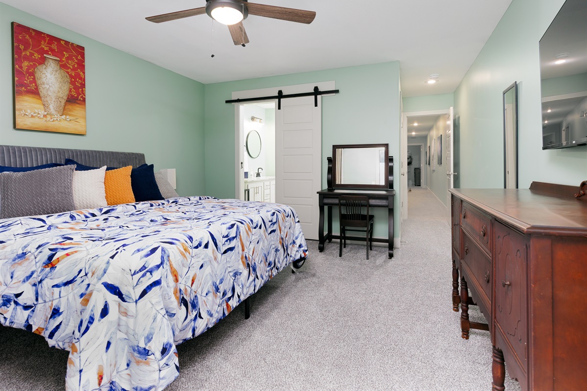Spacious primary bedroom with a king bed, offering comfort, privacy, and a relaxing retreat.