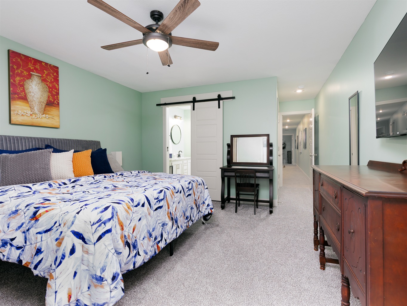 Spacious primary bedroom with a king bed, offering comfort, privacy, and a relaxing retreat.