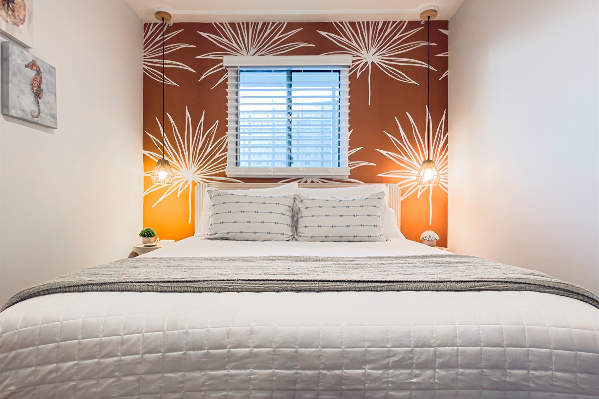 The tropical leaf mural sets a relaxing tone for your entire stay. You will feel completely at home in this calm space including a brand new Queen bed, dresser and TV.