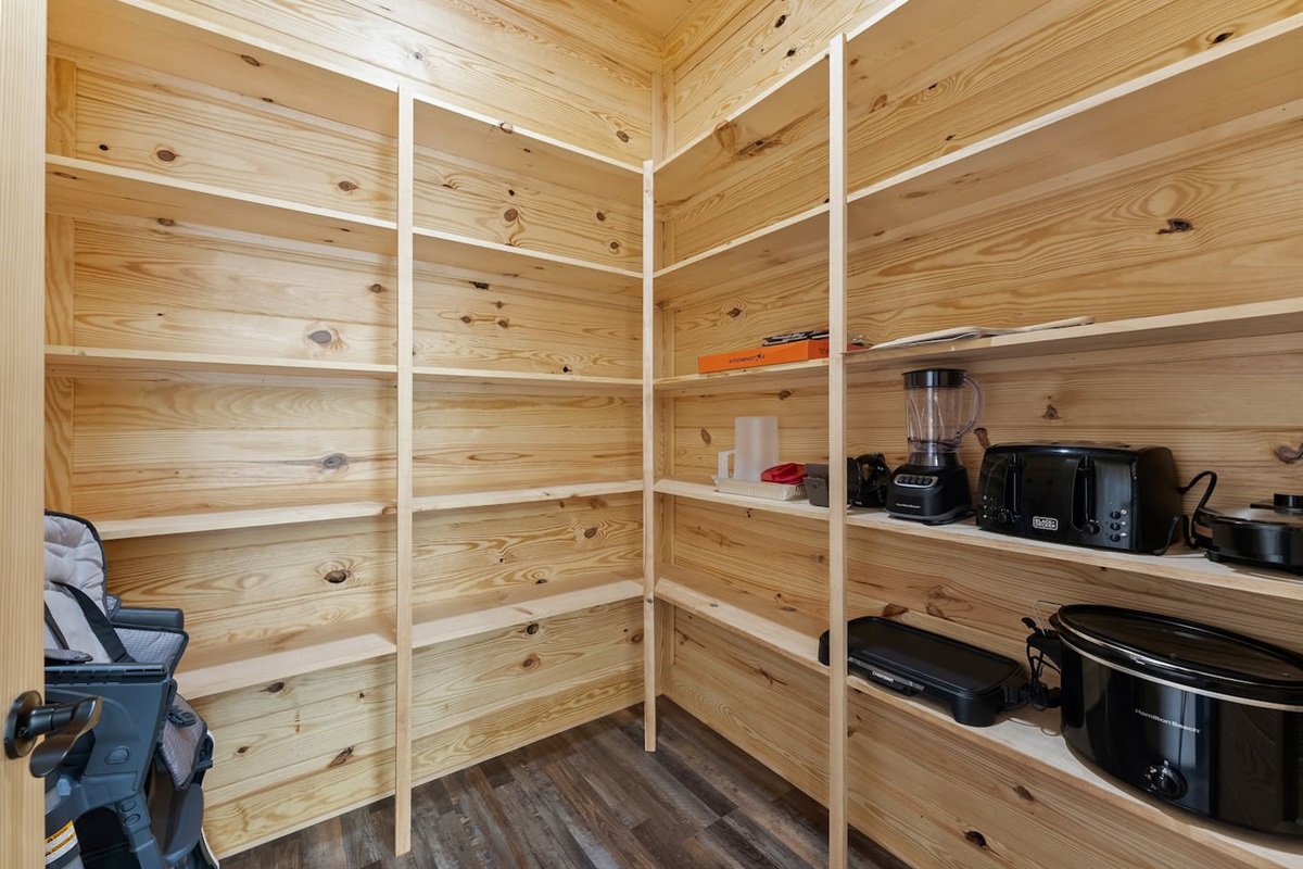Keep your kitchen organized with extra appliances and storage essentials in this walk-in pantry.