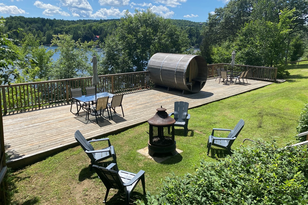 Our natural wood sauna on its deck overlooking Lac McGregor
