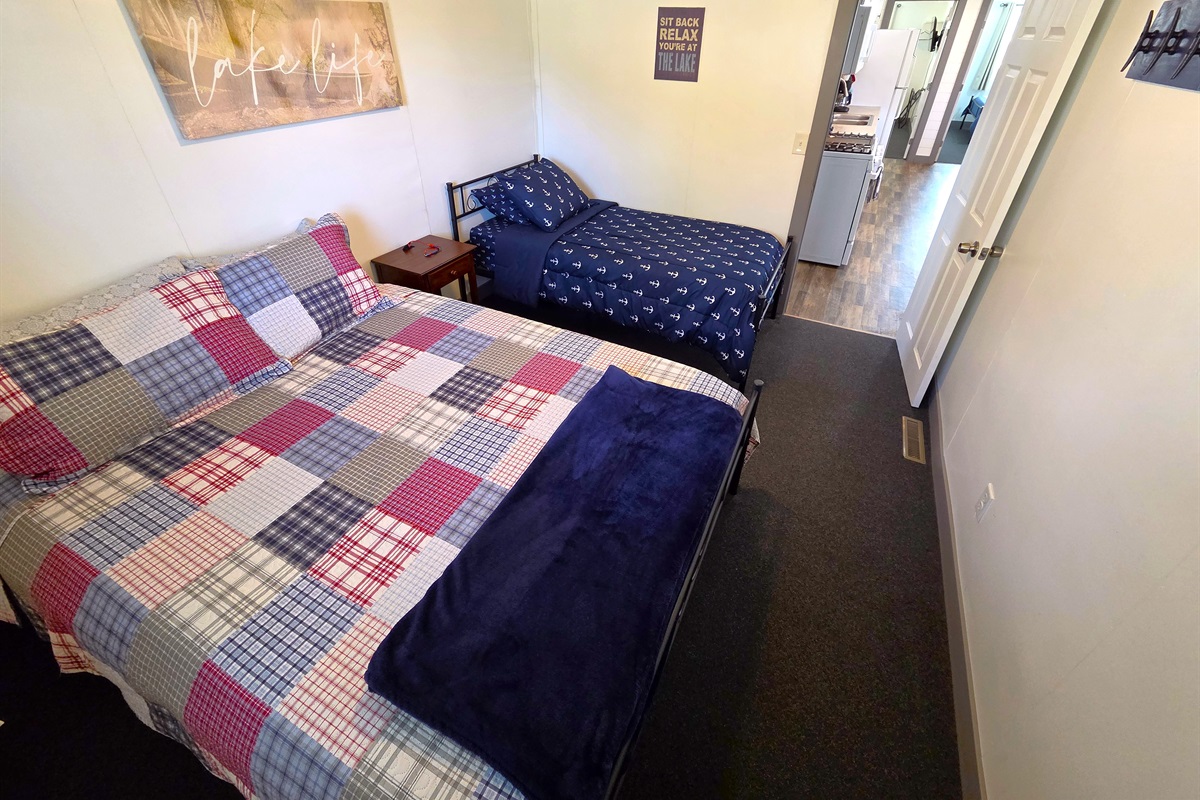 Bedroom 3 has a queen and twin bed & is off the kitchen and 3/4 shower bath.