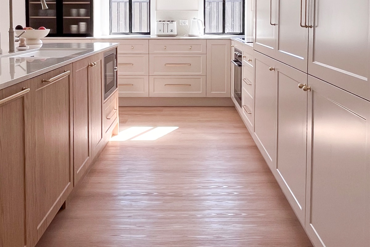 Wide kitchen drawers add useful storage beside the island, helping keep cookware and everyday items within easy reach.