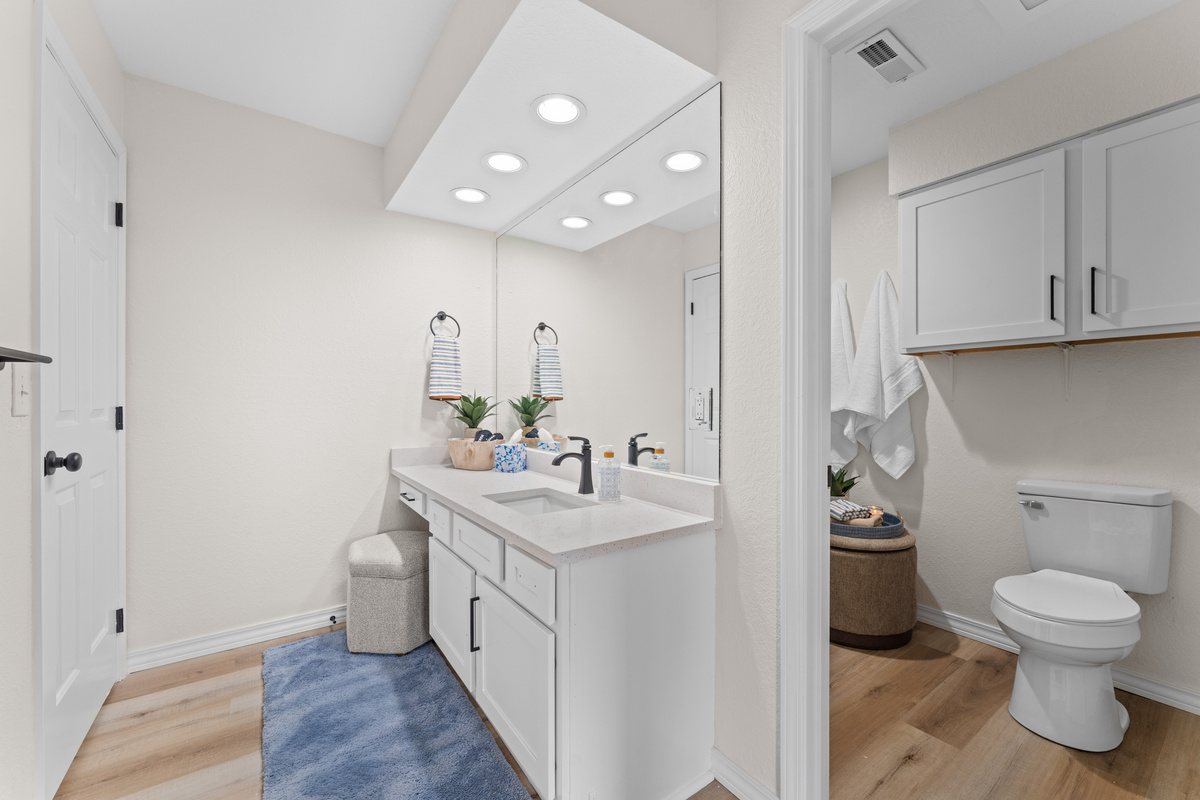 The primary bathroom includes a jetted tub/shower combination, fresh towels, and basic toiletries.