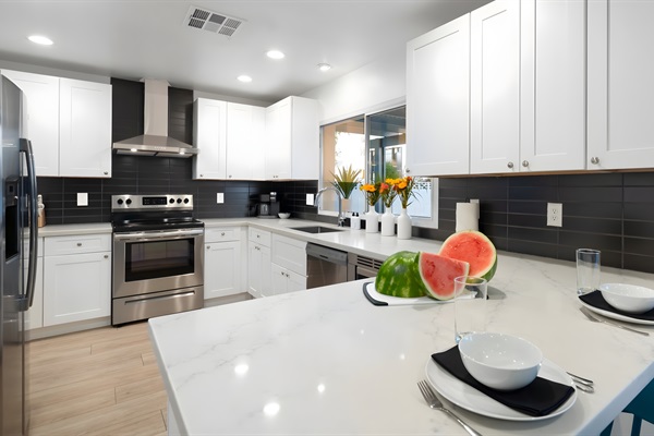 Admire the beautiful kitchen as you serve a casual breakfast at the counter