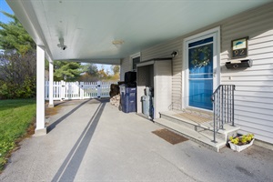 Front door and parking spots with roof