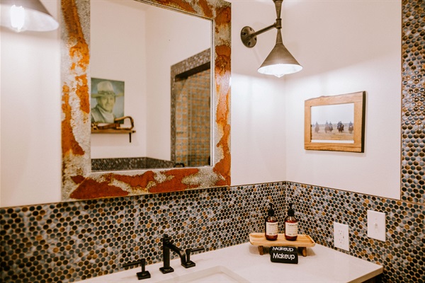 Two private en-suite baths &mdash; one per king bedroom, the rarest layout in a downtown Wimberley 2BR. This is Bath #1, with a walk-in tile shower.